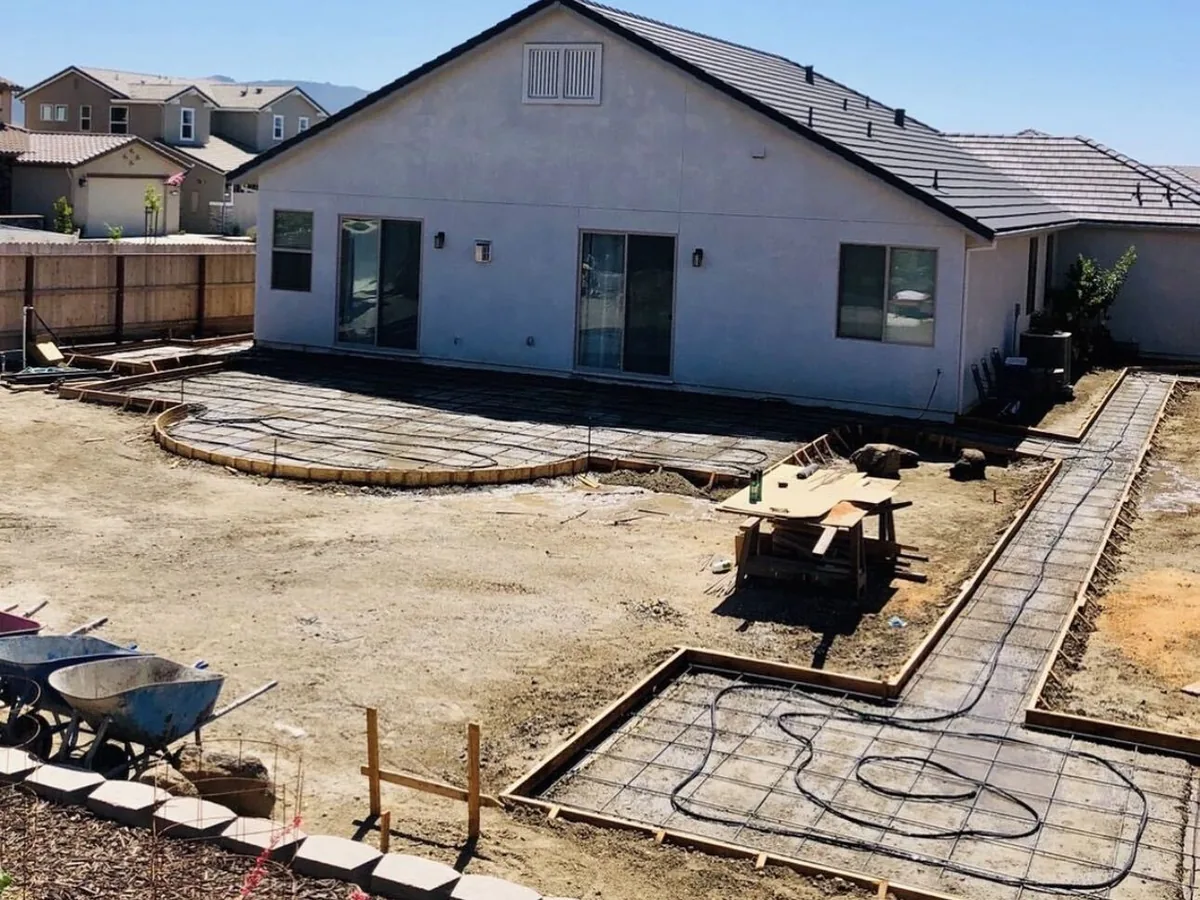 Timber forms and rebar set for a round patio and walkway before the pour